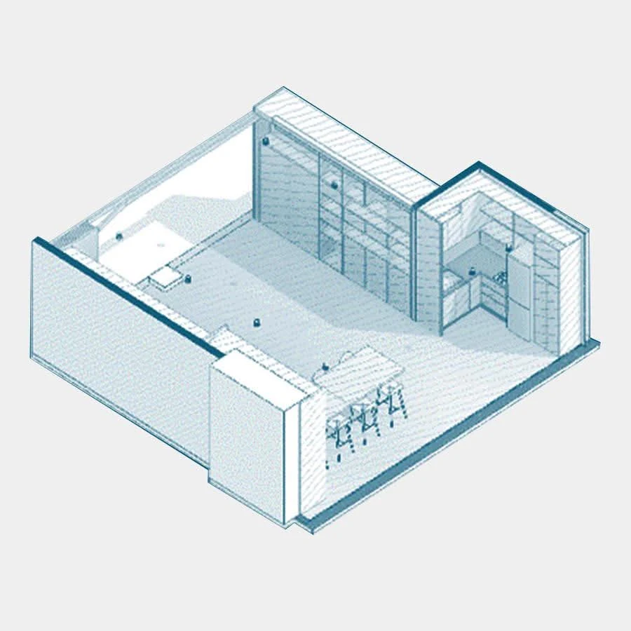 La franja de servicios: un archivo continuo de piso a techo en una pared entera y la cocina en L al fondo, concentrando en una sola banda todo lo que la oficina necesita guardar.